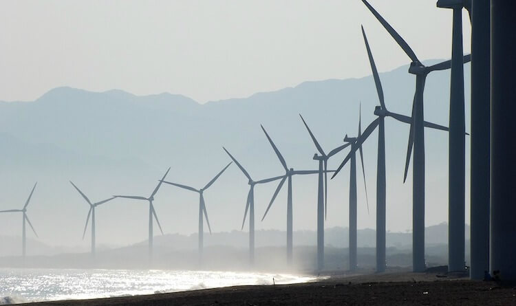 Windenergie-Produktion am Meeresstrand Windkraftanlage an einem Sandstrand